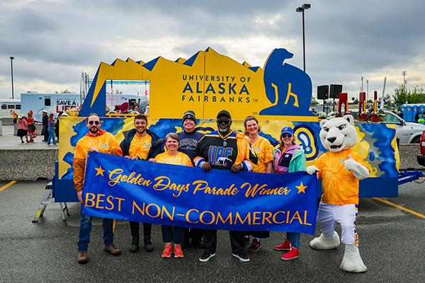 Participants of UAF鈥檚 2023 Golden Days Parade march gather for a group photo before walking through downtown Fairbanks.
